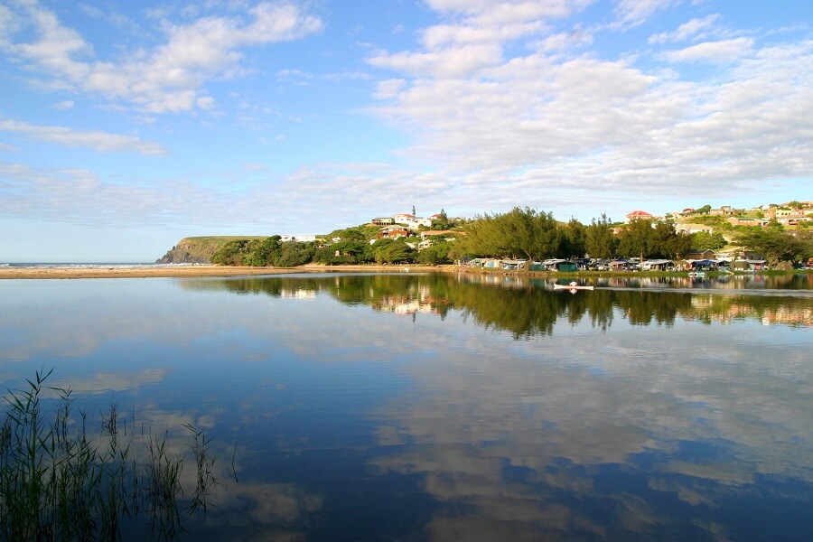 Morgan's Bay lagoon reflecting the sky beside the coastal settlement
